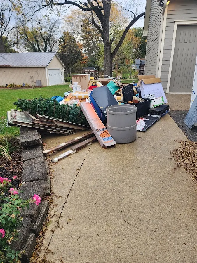 Dumpster being loaded with debris for Demolition Dumpster Rental in Old Westbury